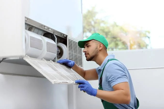 HVAC technician inspecting an indoor air handling system