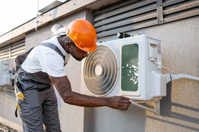 Technician working on a wall-mounted air conditioning unit
